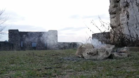 Smoking campfire with a castle in the background Stock Footage 146650048