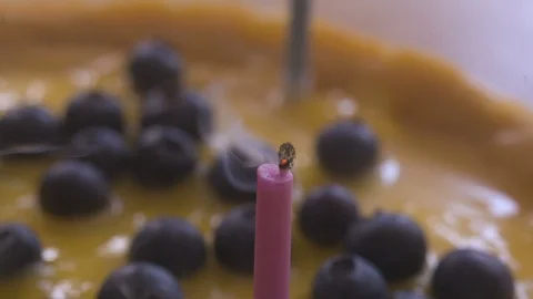 SMOKING CANDLE on a cheesecake Stock Footage 90159100