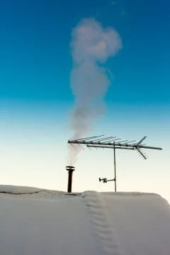 Smoking chimney in winter Stock Photos