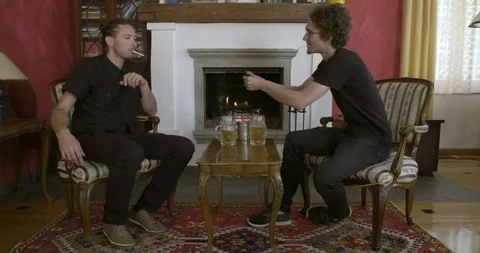 Smoking a cigarette in front of the fireplace Video stock 99740365