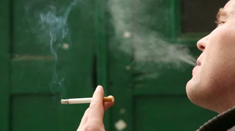 Smoking a cigarette in his hand Stock Footage 32863389