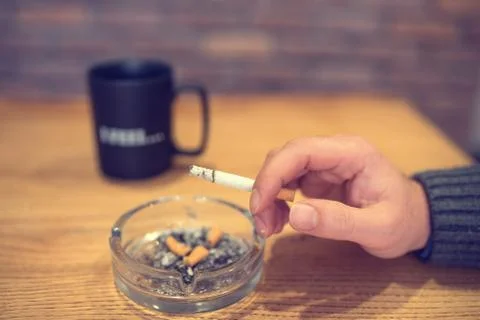 Smoking cigarette on table Stock Photos
