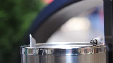 Smoking cigarette with white filter in an iron ashtray in the cafe. Crowd 2 Stock Footage 77998341