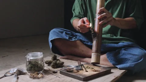 Smoking. Closeup shot of  man lighting a pipe of Marijuana. Man smokes ciga.. Stock Footage 336969269