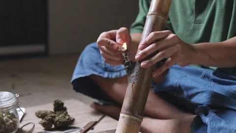 Smoking. Closeup shot of  man lighting a pipe of Marijuana. Man smokes ciga.. Video stock 336969582