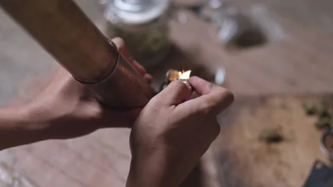 Smoking. Closeup shot of  man lighting a pipe of Marijuana. Man smokes ciga.. Video stock 336969735