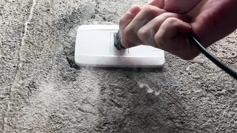 A smoking electrical outlet, a hand pulling the plug out of a burning outlet Stock Footage 317560815