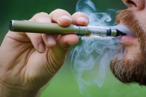 Smoking an electronic cigarette Stock Photos
