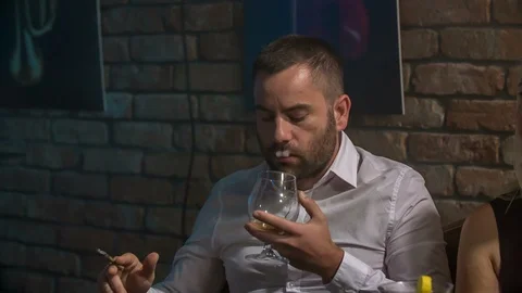 Smoking into an empty glass Stock Footage 112197932