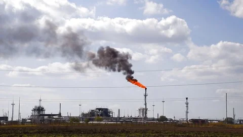The smoking gas torch. Environmental pollution. Torch system on an oil field Stock Footage 85152382