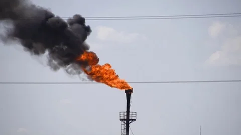 The smoking gas torch. Environmental pollution. Torch system on an oil field Stock Footage 85152487