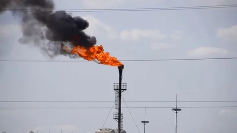 The smoking gas torch. Environmental pollution. Torch system on an oil field Stock Footage 85152650