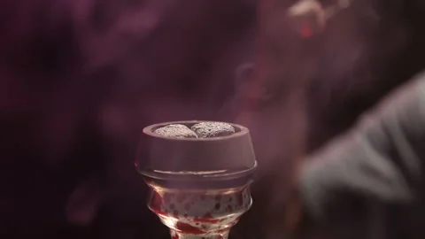 Smoking hookah. The hookah man blows on the coal. Smoking aromatic tobacco Stock Footage 236783020