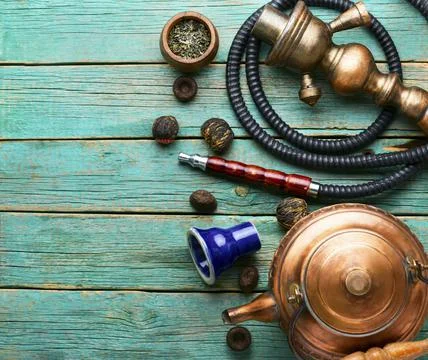 Smoking hookah with tea Stock Photos