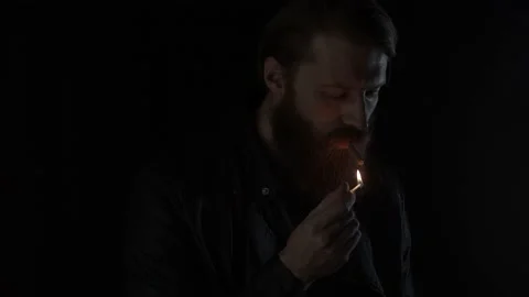 Smoking man on black Stock Footage 131664068