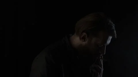 Smoking man on black Stock Footage 131664460