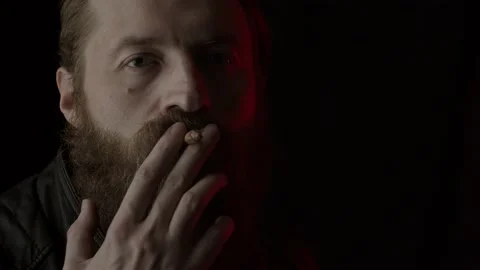 Smoking man on black Video stock 131664752