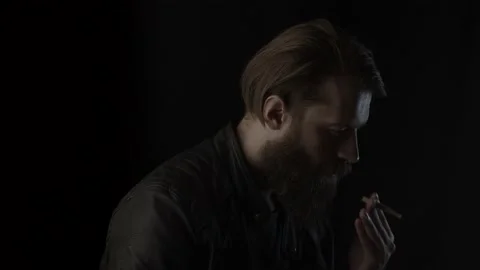 Smoking man on black Stock Footage 131665249
