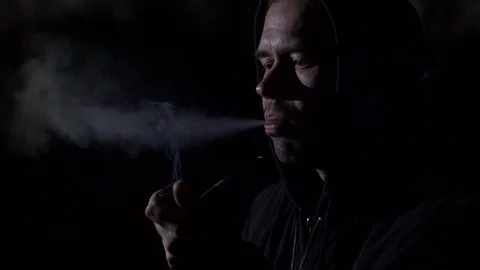Smoking man in the dark. Slow motion Stock Footage 75267401