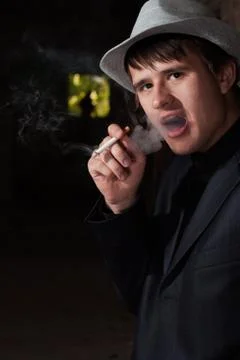 Smoking man in a hat Stock Photos