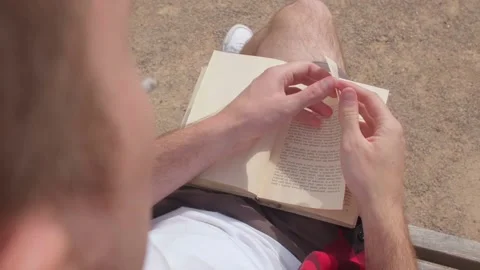 Smoking man reading a book. Finding information to quit a bad habit. Stock Footage 167041844