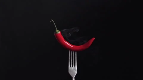 Smoking red chilli pepper on a fork Stock Footage 60711196