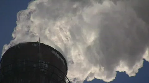 Smoking stack of the thermal power station against a blue sky Stock Footage 586615