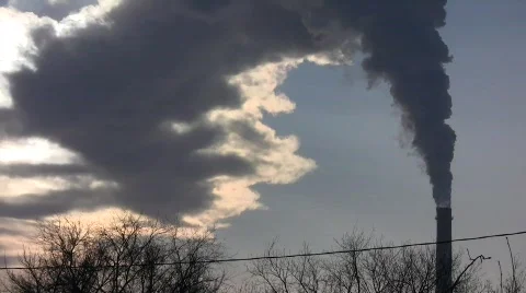 Smoking stack of the thermal power station against an evening sun disk Stock Footage 587507