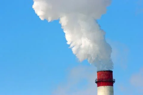 Smoking stack of the thermal power station against a blue sky Stock-Fotos