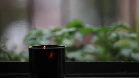 Smoky candle on windowsill Stock Footage 141003085