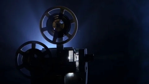 Smoky dark studio. Film rotates reels and vintage movie shows Vidéo 73661663