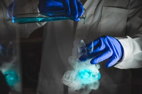 Smoky experiments with blue colour solution.  Scientist working on chemical.. Stock Photos