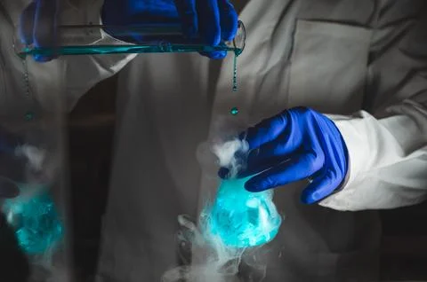 Smoky experiments with blue colour solution.  Scientist working on chemical.. Foto stock
