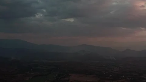 Smoky hills of Pai under a dramatic cloudy sky, rugged mountain silhouettes and Stock Footage 309623326