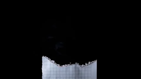 Smoldering Burnt Edge Of Squared Graph Paper Against Black Background Stock Footage 330301102