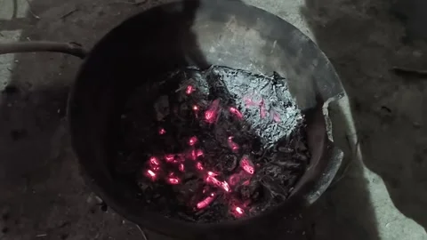 Smoldering charcoal in an earthenware pot. Stock Footage 325007873