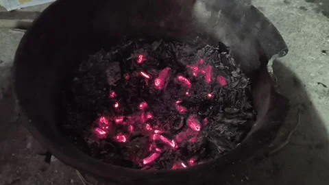 Smoldering charcoal in an earthenware pot. Stock Footage 325007889