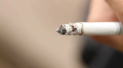 Smoldering cigarette in the hand closeup Stock Footage 65407774