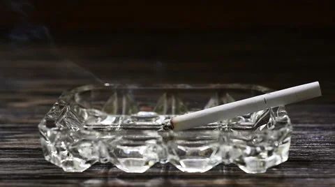 Smoldering Cigarette on the wood background, Timelapse Stock Footage 67475727