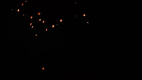 Smoldering coal embers falling and swirling on black background, VFX overlay Stock Footage 343881715