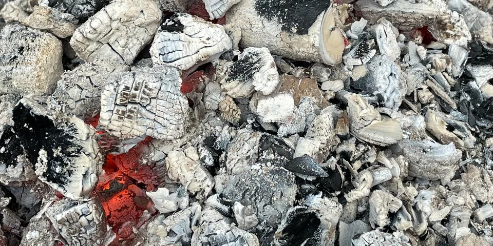 Smoldering coal in a fire, texture. Stock Photos
