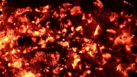Smoldering coals of a fire in a strong wind. Sparks fly out. Stock Footage 168681344