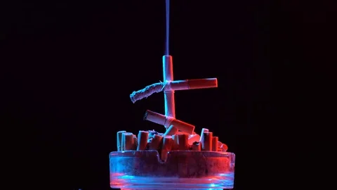 Smoldering cross of cigarettes Vídeo Stock 75604266