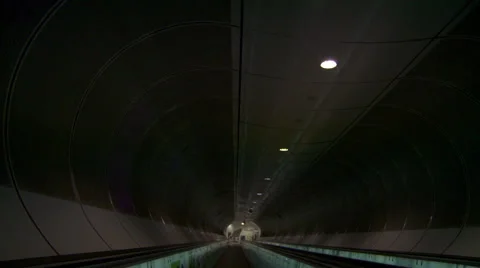 Smooth 180 degrees dolly shot on moving sidewalk through futuristic tunnel Stock Footage 42490814