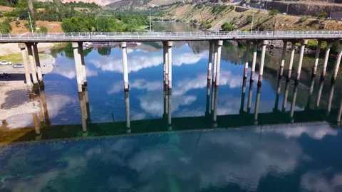 Smooth Aerial Approach Toward Reflective Lake Under Dramatic Cloudy Sky Stock Footage 340183596