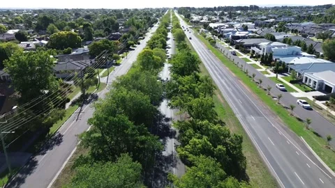 Smooth aerial drone shot flying along a scenic tree lined Video stock 332749652