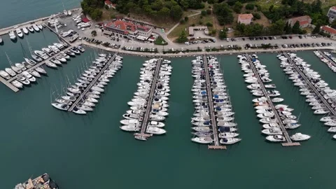 Smooth aerial flight over yachts in a quiet turquoise harbor Stock Footage 322045286