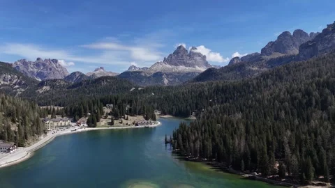 Smooth Aerial Glide Over Green Alpine Lake Revealing Majestic Mountain H Video stock 341304654