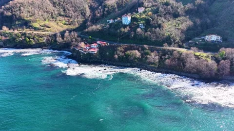 Smooth Aerial Pullback From Coastal Villa Toward Blue Sea Stock Footage 343128837