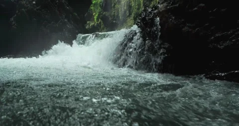 Smooth Aerial River Flow Through Tropical Canyon with Clear Water Stock Footage 332414943